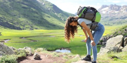 Profile,of,an,exhausted,hiker,resting,after,climbing,a,mountain